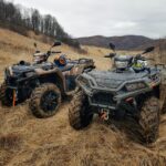 black and gray atv on brown field during daytime