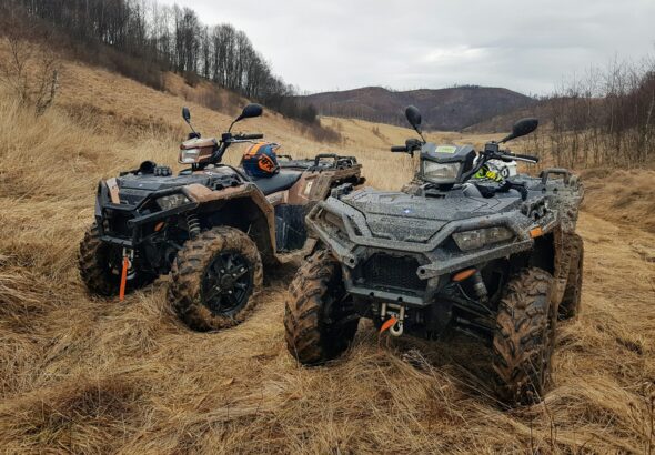 black and gray atv on brown field during daytime