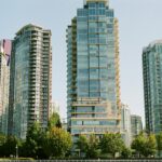 green trees near high rise buildings during daytime